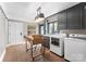 Functional laundry room with gray cabinets, modern washer and dryer, and wooden table at 2015 Pellyn Wood Dr, Charlotte, NC 28226