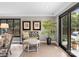 Sitting area with light wood floors, neutral color walls, and view to outside at 2015 Pellyn Wood Dr, Charlotte, NC 28226