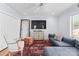 Cozy living room with hardwood floors, a comfortable sofa, and a wall-mounted television at 2015 Pellyn Wood Dr, Charlotte, NC 28226