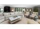 Comfortable living room with neutral tones, stylish furniture, and a large window overlooking greenery at 2015 Pellyn Wood Dr, Charlotte, NC 28226