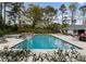 A spacious swimming pool, hot tub, and outdoor patio area surrounded by mature trees and lush landscaping at 2015 Pellyn Wood Dr, Charlotte, NC 28226