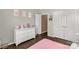 Cozy bedroom with a white dresser, lots of natural light, and warm brown flooring at 2035 Palace Way, Indian Land, SC 29707