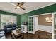 Comfortable living room featuring a ceiling fan, stylish decor, and an open doorway to the hall at 2035 Palace Way, Indian Land, SC 29707
