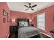 Stylish bedroom with a dark headboard, leopard print throw, and ample natural light from the window at 2035 Palace Way, Indian Land, SC 29707