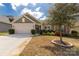Well-maintained home featuring lush lawn, two-car garage, stone accents, and a beautifully landscaped yard at 2035 Palace Way, Indian Land, SC 29707