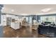 Open-concept living space with dark hardwood floors, blue accent wall, and ample natural light at 2035 Palace Way, Indian Land, SC 29707