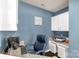 Home office featuring blue walls, a comfortable chair, and a built-in desk with storage cabinets at 2035 Palace Way, Indian Land, SC 29707