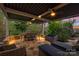 This outdoor patio features stone floors, ample seating, and an overhead pergola for comfortable outdoor living at 2035 Palace Way, Indian Land, SC 29707