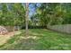 Lush backyard with green grass and a wooden fence, offering privacy and space at 2117 Camp Greene St, Charlotte, NC 28208