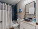 Stylish bathroom with a vessel sink, bathtub, and modern blue tile, creating a spa-like atmosphere at 2117 Camp Greene St, Charlotte, NC 28208