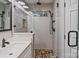 Modern bathroom featuring a frameless shower with rain shower head and pebble flooring at 2117 Camp Greene St, Charlotte, NC 28208
