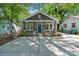 Charming home with a inviting blue front door, stone accents, and a concrete driveway at 2117 Camp Greene St, Charlotte, NC 28208