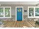 Close-up of the home's front porch with a welcoming blue door and stone accents at 2117 Camp Greene St, Charlotte, NC 28208