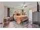 Spacious main bedroom with a ceiling fan, offering a serene retreat with natural light and a seating bench at 2117 Camp Greene St, Charlotte, NC 28208