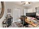 Well-lit home office featuring a natural wood desk, ceiling fan and modern decor with a spacious closet at 2117 Camp Greene St, Charlotte, NC 28208