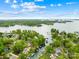 Picturesque aerial view of a charming lakeside community surrounded by lush greenery and tranquil waters at 21220 Rio Oro Dr, Cornelius, NC 28031