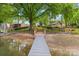 View from dock to backyard featuring a landscaped yard leading up to a charming house with lake access and waterfront living at 21220 Rio Oro Dr, Cornelius, NC 28031