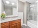 Modern bathroom featuring a glass-enclosed tub, tile flooring, and stylish vanity with granite countertop at 21220 Rio Oro Dr, Cornelius, NC 28031