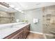 Bathroom boasts granite countertops, stylish vanity, and a modern glass enclosed shower at 21220 Rio Oro Dr, Cornelius, NC 28031