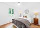 Well lit bedroom offers a comfortable bed, lamp, and bright natural light at 21220 Rio Oro Dr, Cornelius, NC 28031