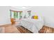 Spacious bedroom with a large bed, sitting area, and bright natural light at 21220 Rio Oro Dr, Cornelius, NC 28031