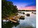 A scenic aerial view showcases a contemporary two-story boat dock on the tranquil waters of Lake Norman at 21220 Rio Oro Dr, Cornelius, NC 28031
