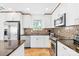 Updated kitchen with stainless-steel appliances, granite counters, and white cabinetry at 21220 Rio Oro Dr, Cornelius, NC 28031