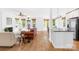 Open-concept living room and kitchen area with hardwood floors, modern stainless appliances, and plenty of natural light at 21220 Rio Oro Dr, Cornelius, NC 28031