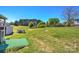 The large grassy backyard includes a storage building and seating at 216 Sylvan Rd, China Grove, NC 28023