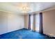 Cozy bedroom featuring blue carpeting, neutral walls, and a ceiling fan for added comfort at 216 Sylvan Rd, China Grove, NC 28023
