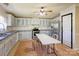 Bright kitchen with white cabinets, stainless steel refrigerator, and tile flooring at 216 Sylvan Rd, China Grove, NC 28023
