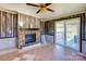 Living area featuring a fireplace, wood paneled walls, and sliding glass door at 216 Sylvan Rd, China Grove, NC 28023
