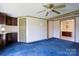 A living room with blue carpeting, a ceiling fan, and a wet bar at 216 Sylvan Rd, China Grove, NC 28023