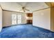 A living room with blue carpeting, a ceiling fan, and a wet bar at 216 Sylvan Rd, China Grove, NC 28023