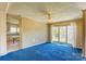 Spacious living room featuring blue carpeting, ceiling fan and natural light from windows at 216 Sylvan Rd, China Grove, NC 28023
