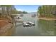 Aerial view of a dock with boat lifts on a serene lake at 2228 Metcalf Dr, Sherrills Ford, NC 28673