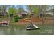 Scenic aerial view of a waterfront home with a private dock on a tranquil lake at 2228 Metcalf Dr, Sherrills Ford, NC 28673