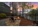 A stone patio with fire pit sits near a fence with lake views providing a serene and private outdoor space at 2228 Metcalf Dr, Sherrills Ford, NC 28673