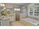 Bright bathroom with dual vanities, glass shower, and a relaxing soaking tub at 2228 Metcalf Dr, Sherrills Ford, NC 28673