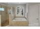 Bathroom featuring a large soaking tub and separate glass-enclosed shower at 2228 Metcalf Dr, Sherrills Ford, NC 28673