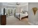 Comfortable bedroom with tray ceiling, large windows, and cozy seating area at 2228 Metcalf Dr, Sherrills Ford, NC 28673