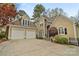 Charming home featuring a two-car garage, stone accents, and well-manicured landscaping enhancing its curb appeal at 2228 Metcalf Dr, Sherrills Ford, NC 28673