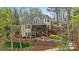 Multi-level home with screened porch, wood deck, stone patio, fire pit and lush landscaping at 2228 Metcalf Dr, Sherrills Ford, NC 28673