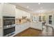 Modern kitchen with white cabinetry, stainless steel double oven, granite countertops, and hardwood floors at 2228 Metcalf Dr, Sherrills Ford, NC 28673