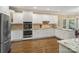 Bright kitchen with white cabinets, stainless steel appliances, granite countertops, and hardwood floors at 2228 Metcalf Dr, Sherrills Ford, NC 28673