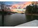 Picturesque lake view with docks, boats and trees under a colorful sky at 2228 Metcalf Dr, Sherrills Ford, NC 28673