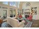 Bright living room featuring a stone fireplace, built-in bookshelves, and large windows at 2228 Metcalf Dr, Sherrills Ford, NC 28673