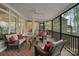 Cozy screened porch featuring comfortable wicker furniture and scenic views at 2228 Metcalf Dr, Sherrills Ford, NC 28673