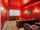 Red home theater room with a large screen, plush seating, and sconce lighting at 2228 Metcalf Dr, Sherrills Ford, NC 28673