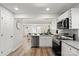 Bright kitchen with stainless steel appliances, white cabinets, and granite countertops opens to the living area at 243 Barber St, Rock Hill, SC 29730